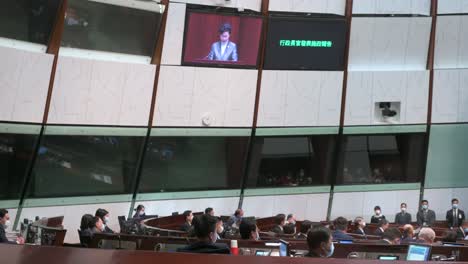 Carrie-Lam,-former-Hong-Kong's-chief-executive,-is-seen-on-the-main-chamber's-screen-as-she-delivers-the-annual-policy-address-at-the-Legislative-Council-building