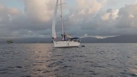 Sunset-drone-fast-shot-of-a-sailboat-San-Blas-Islands-