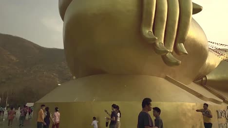 Slow-motion-view-of-golden-big-buddha-in-old-temple,tilt-up-shot