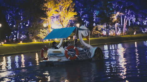 People-Enjoying-a-Night-time-Pedal-Boat-Ride-on-a-Tranquil-Lake