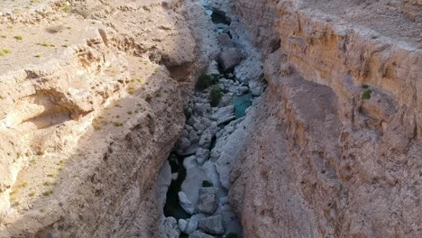 Aerial-of-amazing-Wadi-Tiwi-oasis-with-turquoise-water-and-canyon-in-the-Sultanate-of-Oman