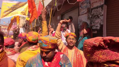 pov-shot-Holi-is-being-played-by-different-temple-employees-in-different-dresses-and-drums-and-different-musical-instruments-are-also-being-played-together