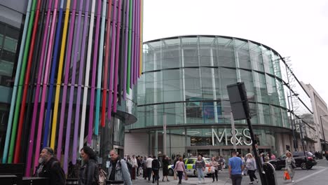 People-Walking-in-Front-of-M-and-S-Bank-Arena,-Liverpool-England-UK,-Slow-Motion