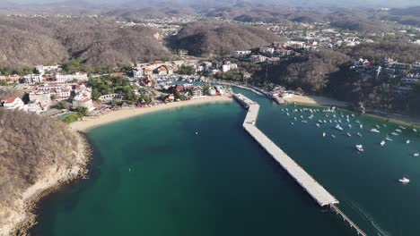 Panoramic-view-of-Huatulco-city,-as-seen-from-the-breathtaking-Santa-Cruz-Huatulco-Bay,-Oaxaca