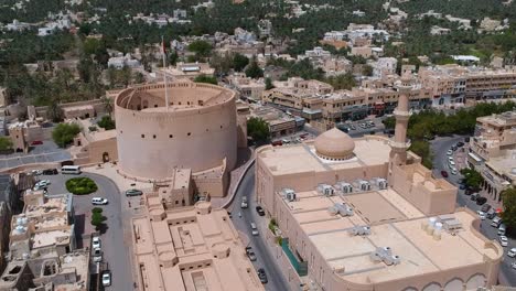Aerial-drone-of-Nizwa-with-historic-fort-and-walls-in-the-Sultanate-of-Oman