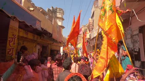 pov-shot-In-the-bazaar-around-the-temple,-a-little-dusty-fun-is-being-enjoyed-by-the-devotees-of-God-dressed-in-different-clothes