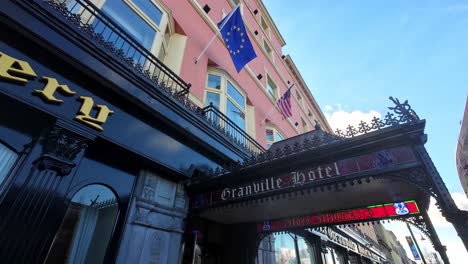 European-and-American-flags-on-hotel-on-quay-in-Waterford-City-Ireland