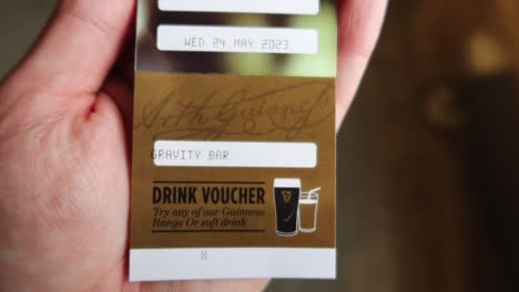 Hand-holding-a-Drink-voucher-for-a-Guinness-beer-in-the-Gravity-Bar