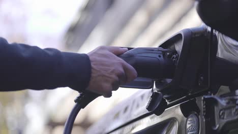 Plugging-in-an-EV-charger-to-an-electric-car