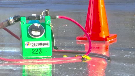 Portable-Gross-Decontamination-System-And-Traffic-Cone-On-Wet-Floor-With-Flowing-Water-After-Fire