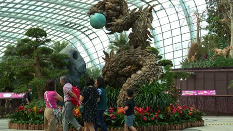 Tilt-up-shot-of-wooden-dragon-sculpture,-the-centrepiece-of-Flower-Dome-glass-greenhouse-conservatory-at-Gardens-by-the-bay-during-festive-season,-to-celebrate-Lunar-new-year