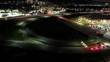 night-time-timelapse-of-the-on-off-ramp-on-California-Highway-10-Redlands-freeway-merging-with-South-Tippecanoe-Ave-in-San-Bernardino-busy-traffic-long-exposure-headlights-AERIAL-STATIC