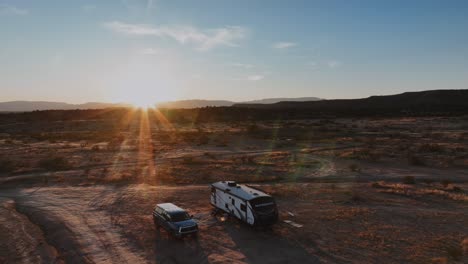 Recreational-Vehicle-And-SUV-At-Caravan-Park-On-Sunny-Desert-Morning,-USA
