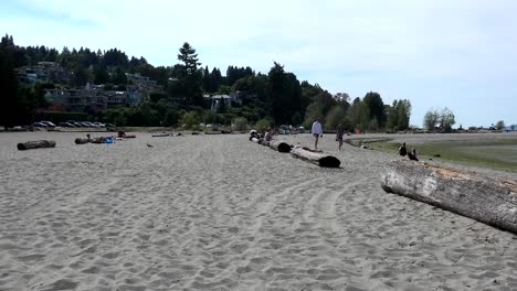 Locarno-beach-couple-walking,-ocean-views-of-English-Bay-at-Vancouver