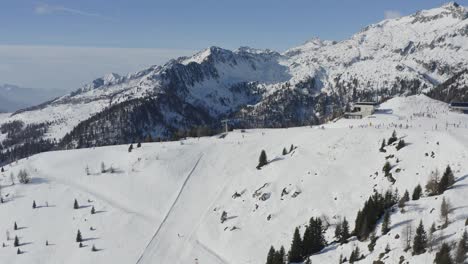 Winter-sports-excitement,-snow-covered-Folgarida-ski-pistes,-scenic-aerial-Dolomites