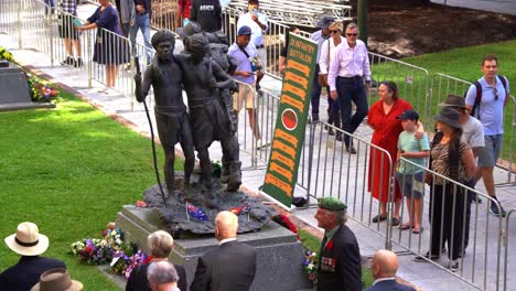 Families-of-war-heroes-and-representatives-from-the-39th-Infantry-Battalion-gathered-at-the-bronze-statue-of-the-South-West-Pacific-Campaign,-mourning-and-honoring-those-who-served-during-wartime