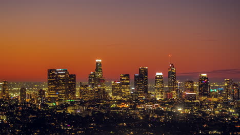 Timelapse,-Night-Over-Los-Angeles-Downtown-Buildings-and-Skyscrapers,-Purple-and-Orange-Sky-and-Lights