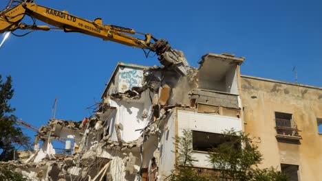 Excavator-Equipment-With-Long-Arm-Breaking-Old-Building-Structure-In-Israel