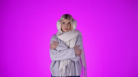 Woman-is-freezing-and-shaking-because-of-the-cold,-violet-studio-background