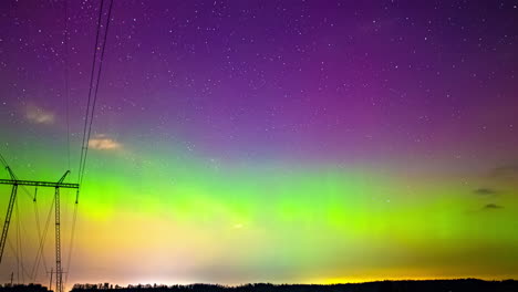 Time-lapse-of-the-Northern-Lights-illuminating-the-sky-near-powerlines
