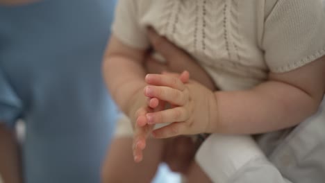 Clasped-hands-of-mother-and-baby