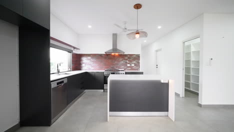 Dolly-across-Newly-Built-Empty-Open-Plan-Kitchen-Dining-and-Lounge-with-minimal-furniture