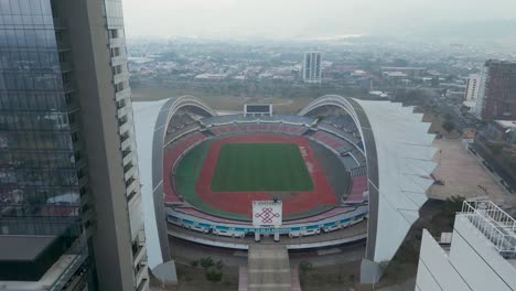 Drone-Shot-Pulling-Away-from-National-Stadium-on-Cloudy-Day
