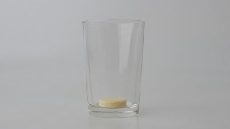 Yellow-Effervescent-Tablet-Drop-On-A-Clear-Glass