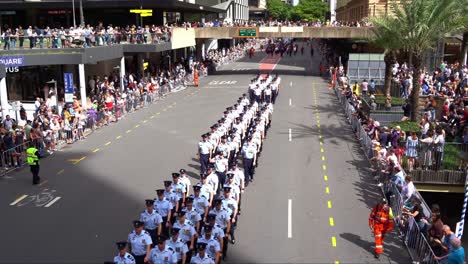 Disciplined-airmen-and-airwomen-from-Royal-Australian-Air-Force-army-uniformly-marching-down-Adelaide-Street,-Brisbane-city,-amidst-the-solemnity-of-the-Anzac-Day-commemoration