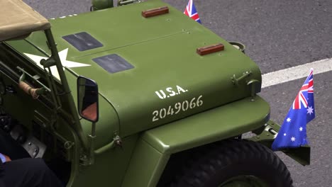 Close-up-shot-of-Vintage-military-vehicle-driving-down-the-street-during-the-annual-Anzac-Day-parade-tradition-at-Brisbane-city