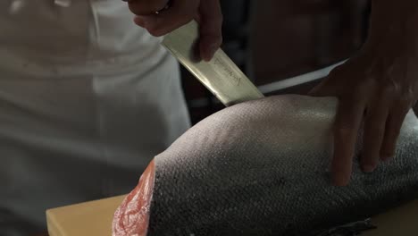 Chef-preparing-fresh-salmon-in-the-kitchen