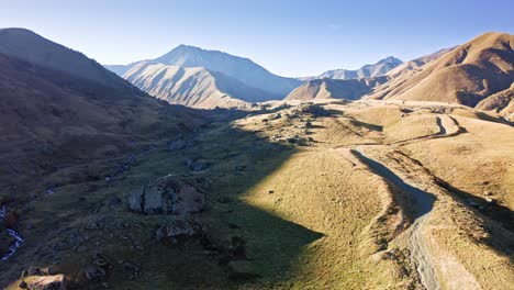 Aerial-view-of-mountain-valley-sunlit-by-sunset-in-Georgian-region-of-Tusheti