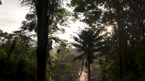 View-of-a-tropical-landscape-in-Salento-city-in-Colombia,-sunset-through-the-trees
