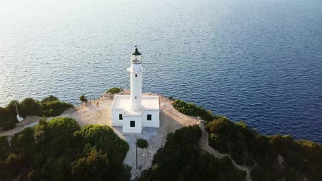 Sunset-at-lighthouse-in-Doukato-Lefkada-Greece,-aerial-reveal,-panning