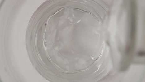 Macro-slow-motion-top-shot-of-water-filling-a-glass