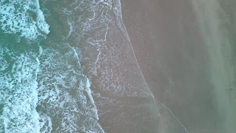 Waves-meeting-sand-from-an-aerial-viewpoint