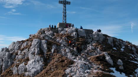 Italian-flag-and-hikers-at-Resegone-cross-on-top-of-mountain-in-northern-Italy