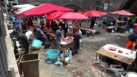 Italian-outdoor-seafood-market-with-working-washing-down-stall-at-end-of-day