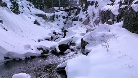 Aerial-pan-up-of-water-stream-and-waterfall,-Eagle-Falls,-Desolation-Wilderness,-Lake-Tahoe,-California