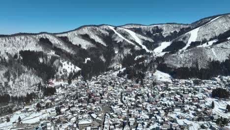 Aerial-establishing-shot-of-Japans-Nozawaonsen-Mountain-Ski-Resort-Village