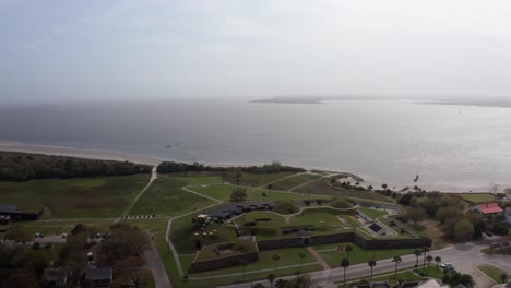 High-panning-aerial-shot-of-historic-Fort-Moultrie-along-the-Atlantic-Ocean-on-Sullivan's-Island,-South-Carolina