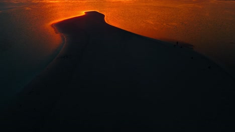 Flaming-orange-sunset-shining-on-an-exotic-beach