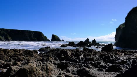 Timelapse-rugged-coast-sea-stacks-sea-spray-and-white-waves-and-blue-skies-Copper-Coast-Waterford-Ireland