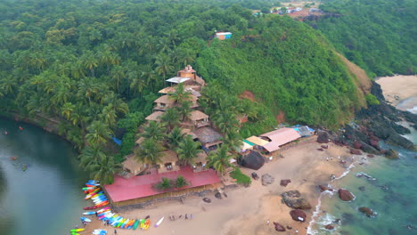 Aerial-view-of-colorful-boats-on-a-sandy-Cola-beach-Goa-India-Drone