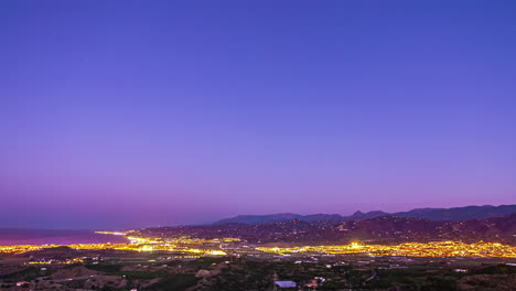 Timelapse-of-nightlife-in-Malaga,-purple-hue-sunrise-at-Alboran-sea,-Spain