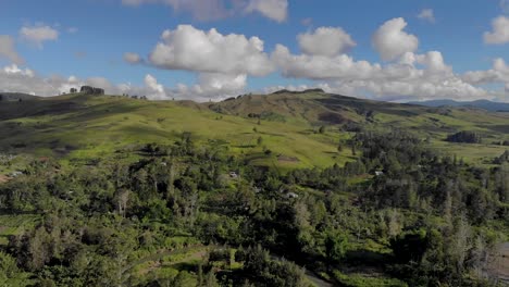 Cinematic-aerial-of-green-hills-and-blue-sky,-Papua-New-Guinea-highlands-landscape