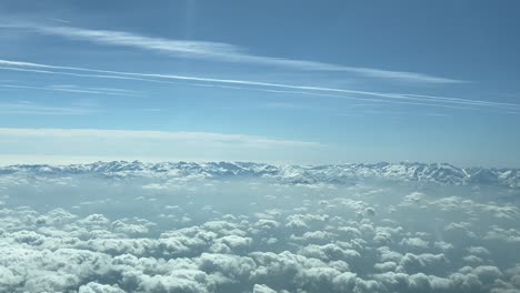 POV-immersive-view-of-the-Snowed-italian-Alps-shot-from-an-airplane-cabin