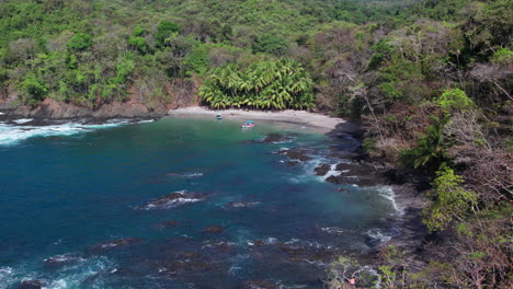 Aerial-dolly-shot-towards-boats-anchored-at-a-quiet-beach-at-Cebaco-Island