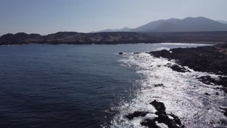 Spectral-sunshine-reflects-off-ocean-along-jagged-rustic-Chile-coast