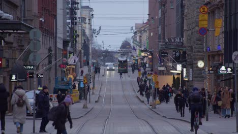 Fast-motion-time-lapse-of-transit-trams,-pedestrians-on-urban-street